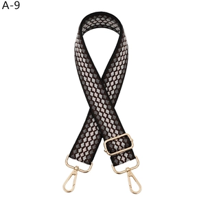 Close-up of adjustable leopard print bag strap with polished gold-tone lobster clasps