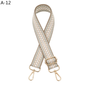 Adjustable jacquard bag strap with green geometric diamond pattern and gold metal clips