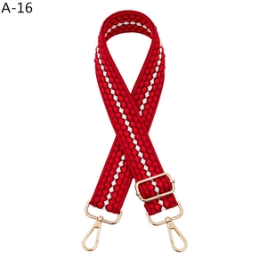 Adjustable red and white woven shoulder strap with gold swivel hooks for handbags