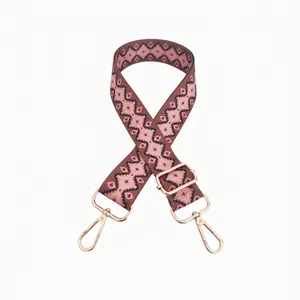 Close-up of geometric ethnic pattern bag strap with gold metal lobster clasps