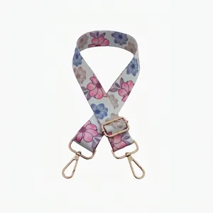 Adjustable floral bag strap featuring pink and blue flowers with gold-tone metal hooks