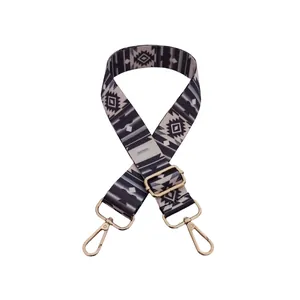 Close-up of bohemian pattern woven bag strap with adjustable gold metal hardware buckles