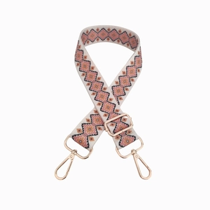 Adjustable ethnic style bag strap with pink geometric pattern and gold hardware hooks