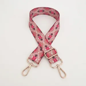 Adjustable crossbody bag strap with ethnic geometric pattern in pink and red tones