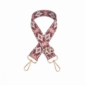 Adjustable woven shoulder strap with pink and brown geometric patterns and gold metal clips