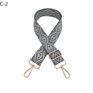 Close-up of diamond pattern adjustable woven bag strap with rose gold metal hooks
