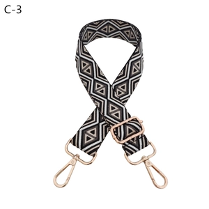 Detail of adjustable bag strap with black and white diamond weave and rose gold hardware