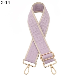 Detail of lavender geometric patterned bag strap with golden metal lobster clasps