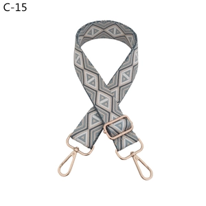 Macro detail of adjustable blue diamond pattern bag strap with rose gold metal lobster clasps