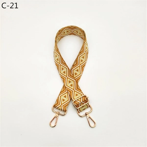 Close-up of orange and white diamond pattern wide adjustable strap with gold metal hardware