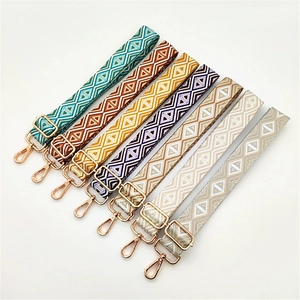 Macro detail of eight bohemian style woven shoulder straps with gold metal clasps