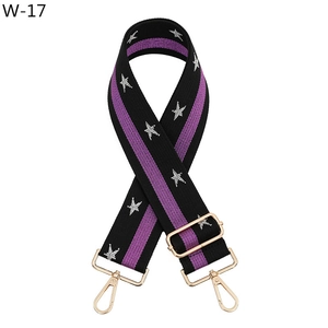 Close-up of ethnic style wide strap with silver star prints and golden metal hooks