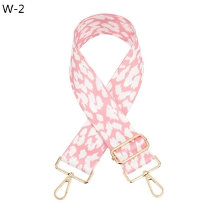 Detail of adjustable wide shoulder strap with pink leopard pattern and gold metal hooks