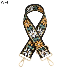 Detail of adjustable floral canvas bag strap with golden hardware and sunflower pattern