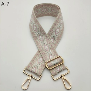 Detailed view of pink and grey jacquard rhombus pattern on wide adjustable bag strap