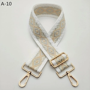 Detail view of bohemian jacquard wide strap with geometric patterns and gold swivel hooks