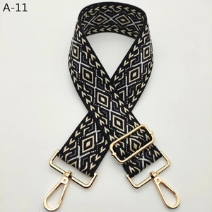 Close-up of jacquard geometric diamond strap with adjustable golden metal buckles
