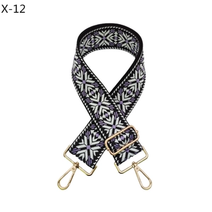 Close-up of adjustable strap with purple ethnic pattern and gold metal buckles