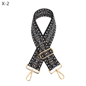 Macro view of adjustable wide shoulder strap with black and white diamond jacquard weave