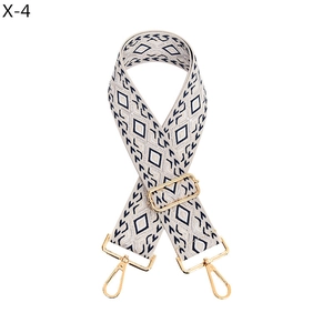 Macro shot of adjustable jacquard woven strap with geometric rhombus pattern and gold metal hooks