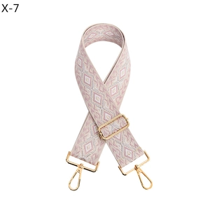 Detail of adjustable geometric woven strap with gold lobster clasps in pink and white