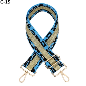Macro view of blue leopard pattern bag strap with gold glitter stripe and metal swivel hook