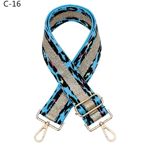 Detail of blue leopard jacquard bag strap with silver glitter thread and gold metal hooks