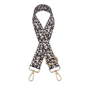 Detail of adjustable leopard print bag strap with polished gold-tone metal snap hooks