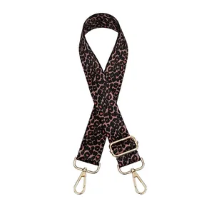 Detail of adjustable leopard print bag strap with polished gold-tone metal lobster clasps