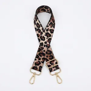 Detail view of adjustable leopard print bag strap with golden metal lobster clasps