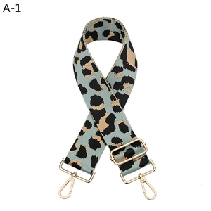 Detail view of leopard print wide strap with golden adjustable buckle and lobster clasps