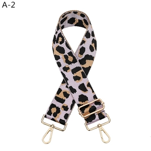 Leopard print woven bag strap in purple and black with adjustable gold metal hooks