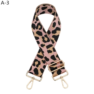 Close-up of pink leopard print wide nylon strap with light gold metal swivel hooks