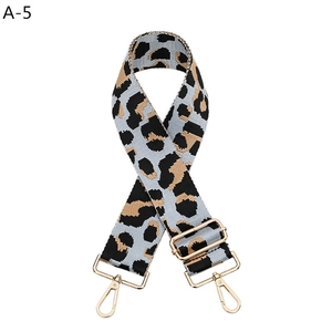 Close-up of leopard print wide strap with gold-tone hardware and adjustable buckle for bags