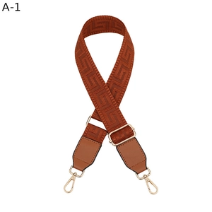 Adjustable brown nylon shoulder strap with Greek key pattern and gold metal hooks
