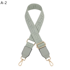Adjustable sage green shoulder strap with geometric Greek pattern and gold metal hooks