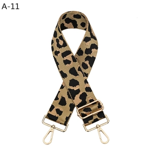 Detailed close-up of leopard print canvas strap with adjustable light gold metal hooks