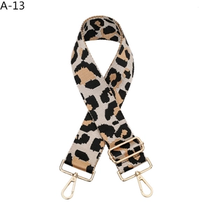 Detail of leopard print bag strap with golden lobster clasp and adjustable metal buckle