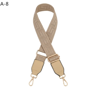 Adjustable woven shoulder strap for bags with beige geometric patterns and gold metal hooks