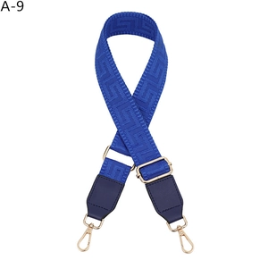 Adjustable blue geometric jacquard fabric bag strap with golden metal hooks and leather trim