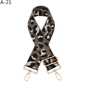 Detail of adjustable leopard print shoulder strap with golden metal lobster clasps