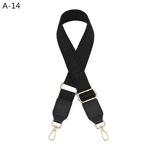 Adjustable black strap with geometric pattern, gold metal hooks and leather connectors
