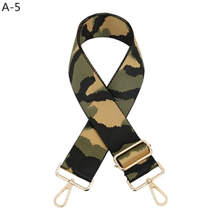 Detailed macro view of camo canvas strap with golden metal lobster clasps and slider buckle
