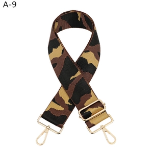 Detail of adjustable camouflage bag strap with premium gold metal swivel hooks and buckles