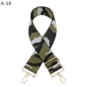 Detail of adjustable camouflage bag strap featuring premium golden lobster clasps