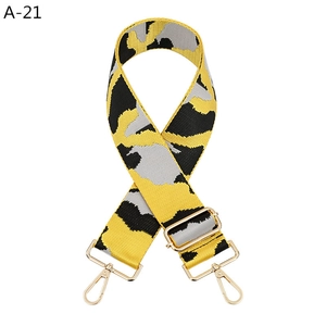 Close-up of yellow and grey camouflage strap with golden metal lobster clasps