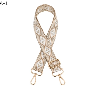 Detail of adjustable geometric strap with champagne gold diamond pattern and metal clasps
