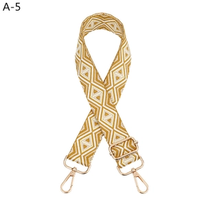 Detail of adjustable geometric diamond pattern bag strap with gold metal lobster clasps