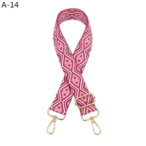 Detail of adjustable geometric diamond pattern bag strap with gold metal swivel hooks