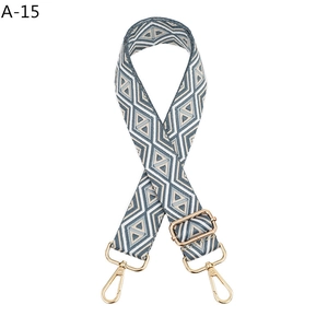 Detail of adjustable woven bag strap with blue and grey geometric diamond pattern